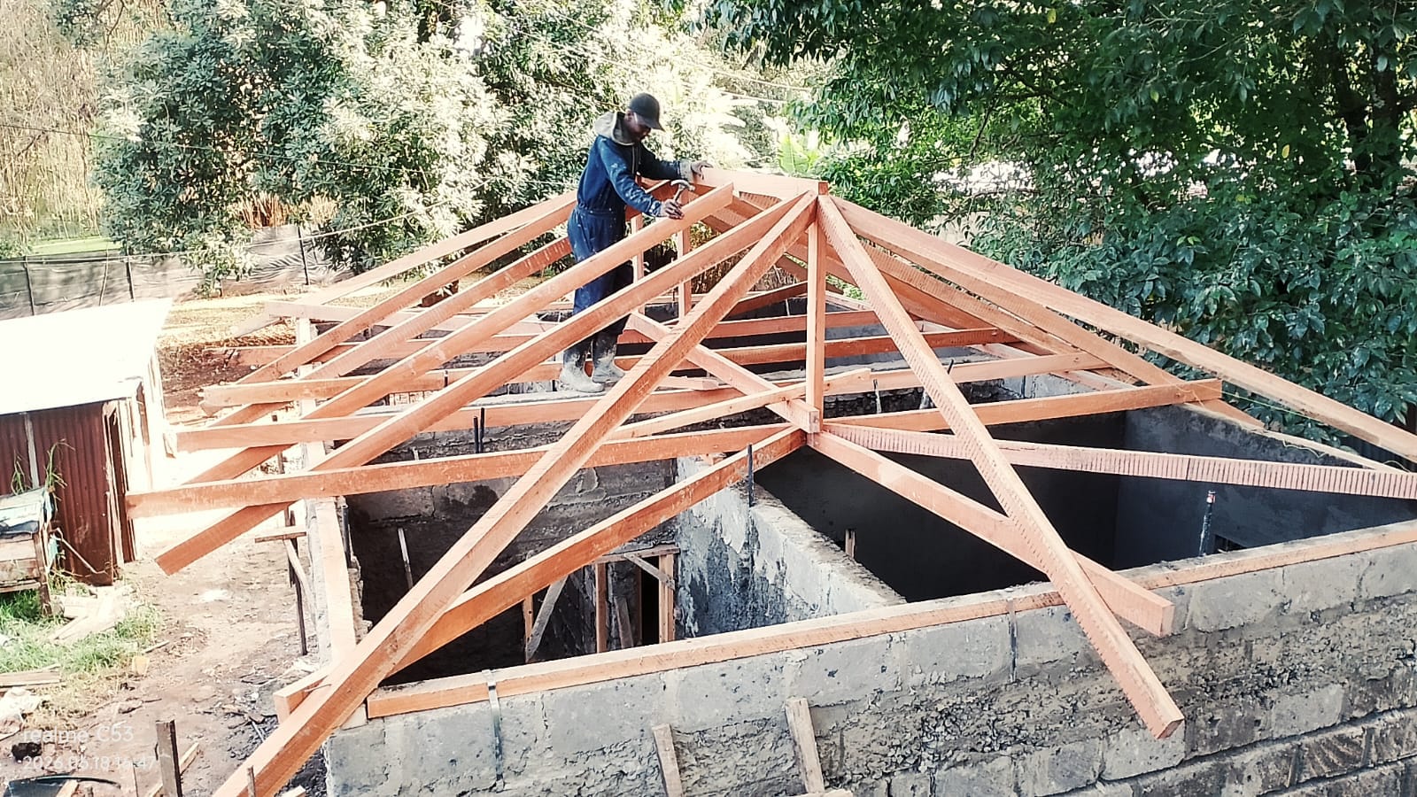 Worker installing roof trusses